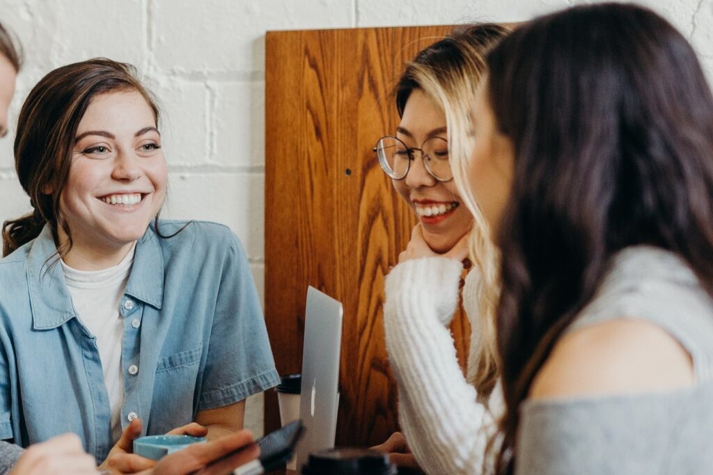 Diverse group of women talking and laughing with each other