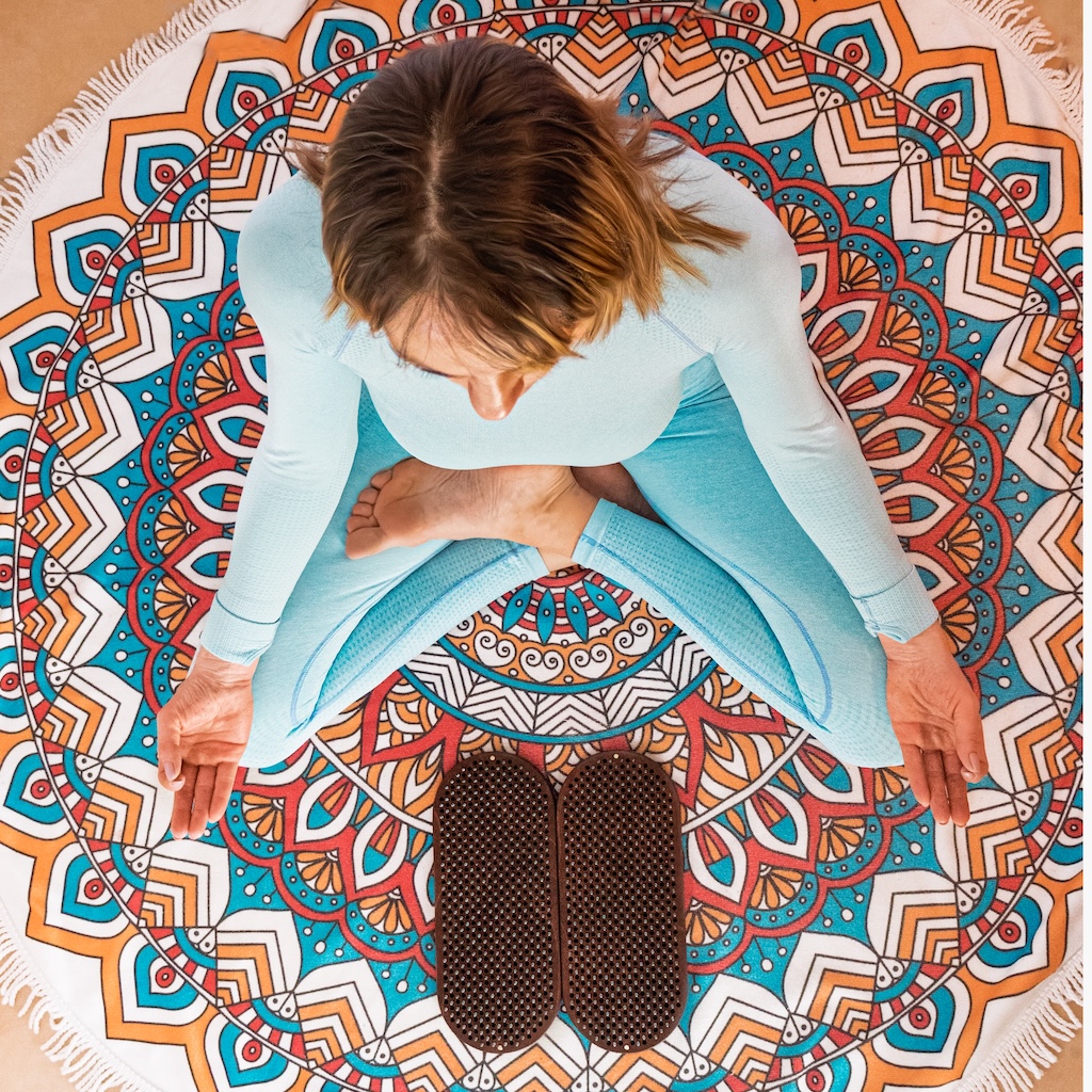 Woman sitting in lotus pose, representing holistic treatment for PMDD.