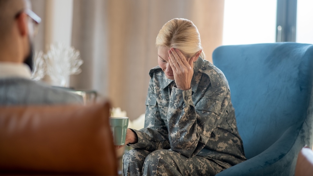 Blonde female military member getting upset while seeking treatment