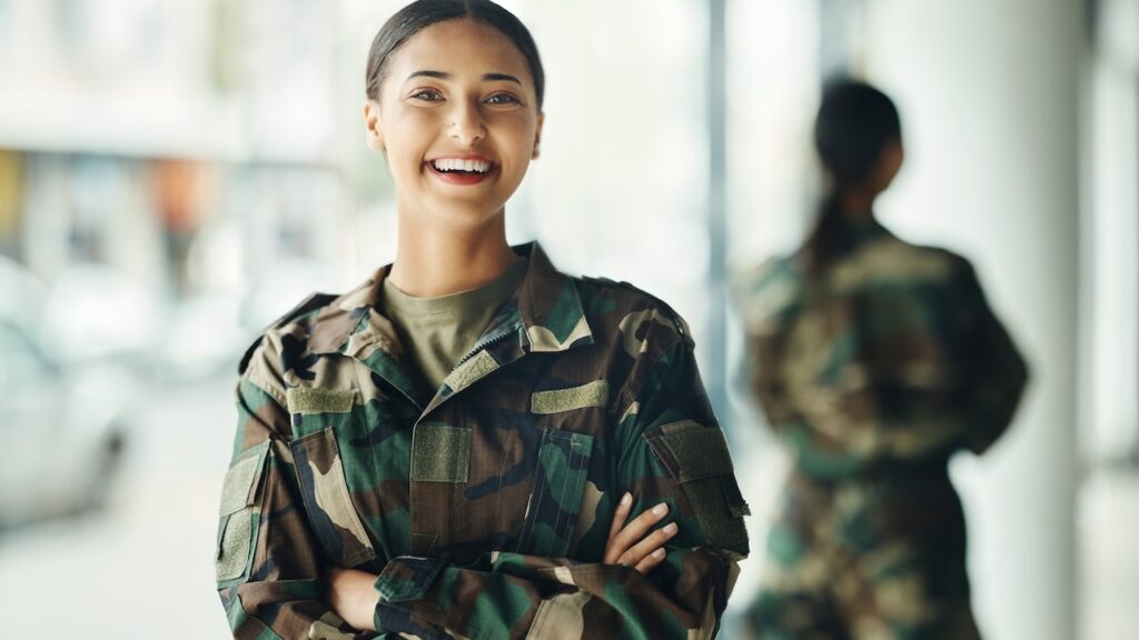 Portrait, soldier and woman with arms crossed, military and security with a smile, confident