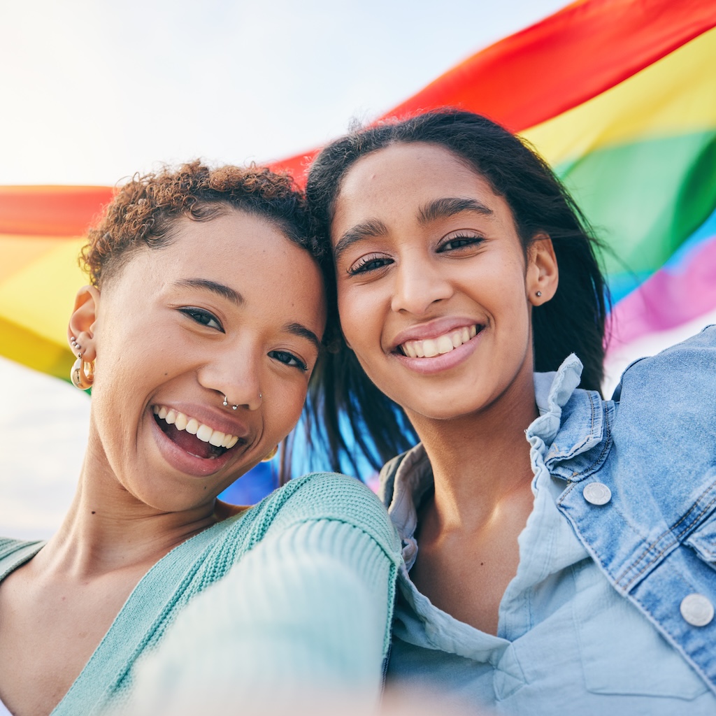 Portrait of two women in selfie, pride flag and lgbt representation