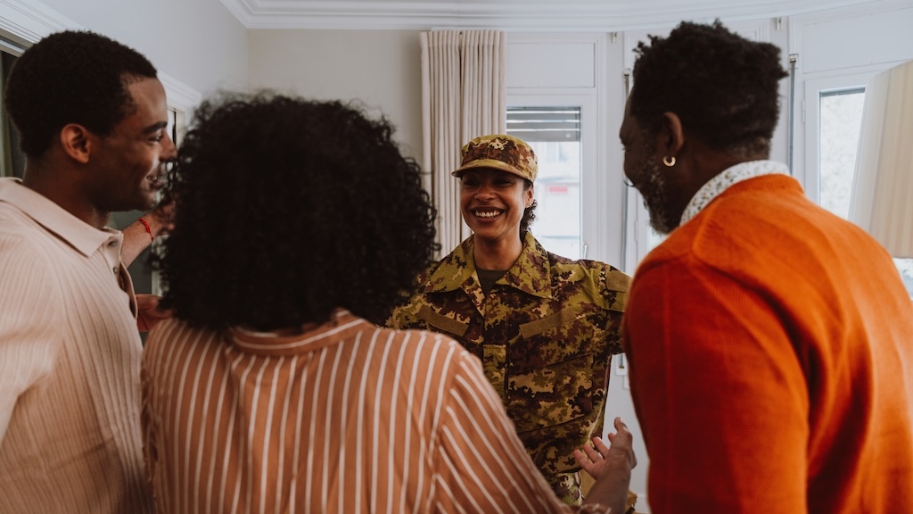 Young female soldier leaving and greeting the family after the holidays.