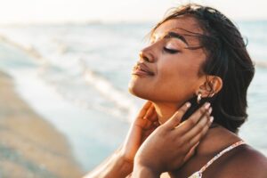 Beautiful female breathing fresh air outside - Health care and wellness concept