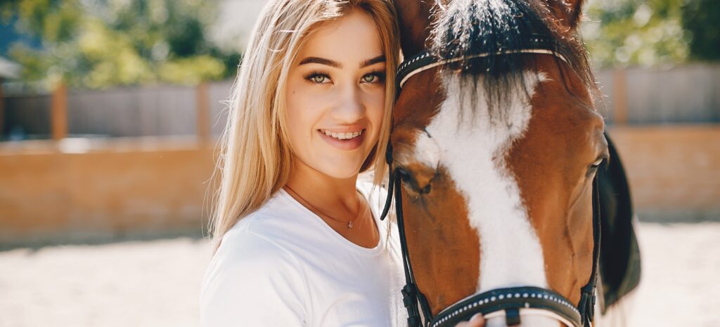 Cute girl with a horse in a white t shirt