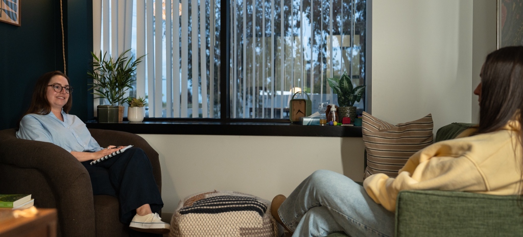 Therapist meeting with a client in a counseling office at Monima Wellness.