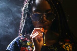 Woman vaping cannabis, illustrating the Cali sober approach to recovery.